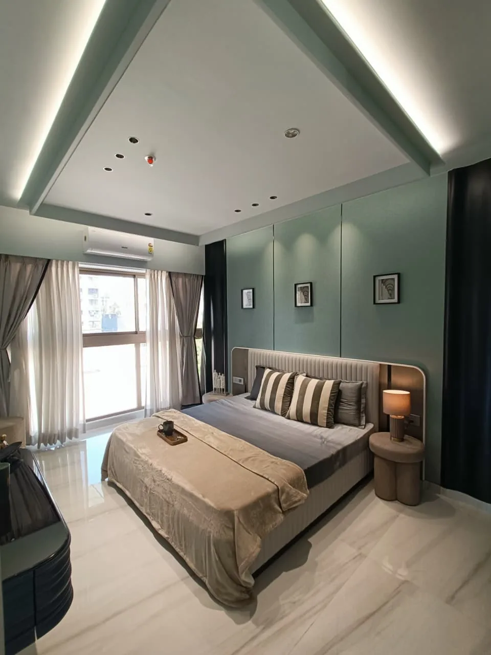 Show flat bedroom with sage accent wall